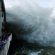 People watch as Hoa Binh hydroelectric power plant opens its flood gates after a heavy rainfall caused by a tropical depression in Hoa Binh province, outside Hanoi on Oct. 12.